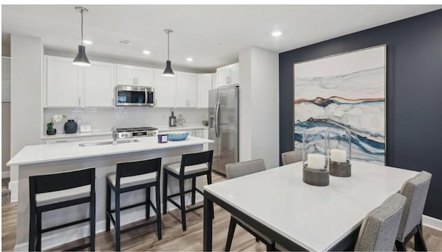 dining area with hardwood / wood-style floors and sink