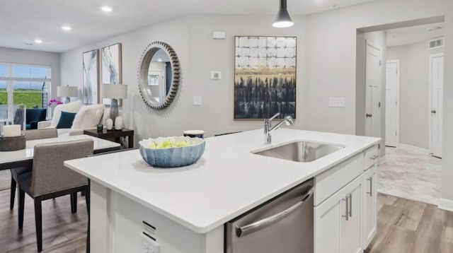 kitchen with dishwasher, sink, an island with sink, decorative light fixtures, and white cabinets