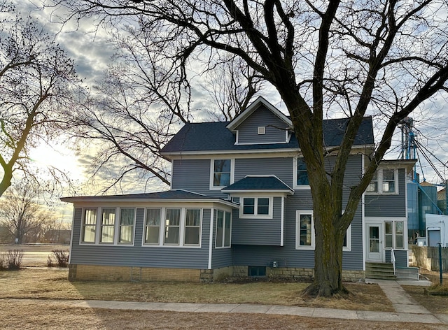 back of house with a sunroom