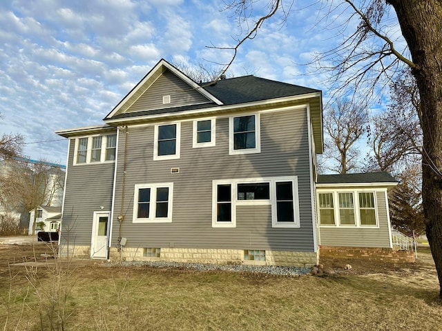 back of property featuring a lawn