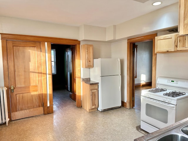 kitchen with radiator, light brown cabinets, and white appliances