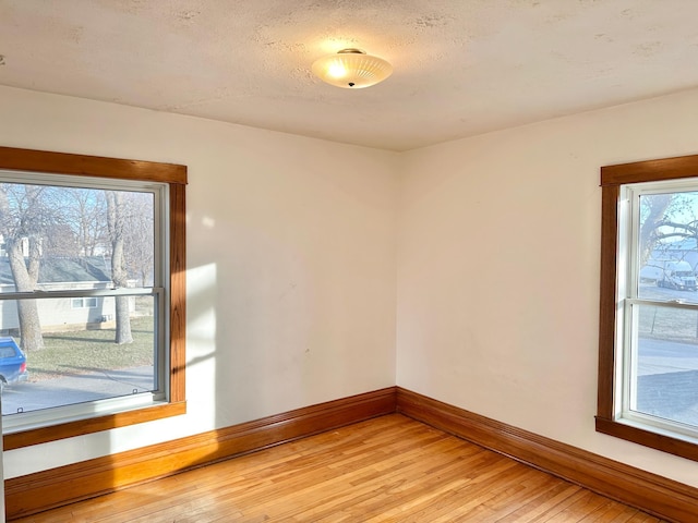 spare room with wood-type flooring and a textured ceiling