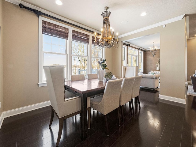 dining area with dark hardwood / wood-style floors, crown molding, and an inviting chandelier