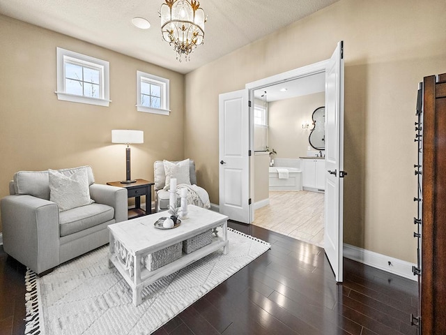 living area with a textured ceiling and an inviting chandelier