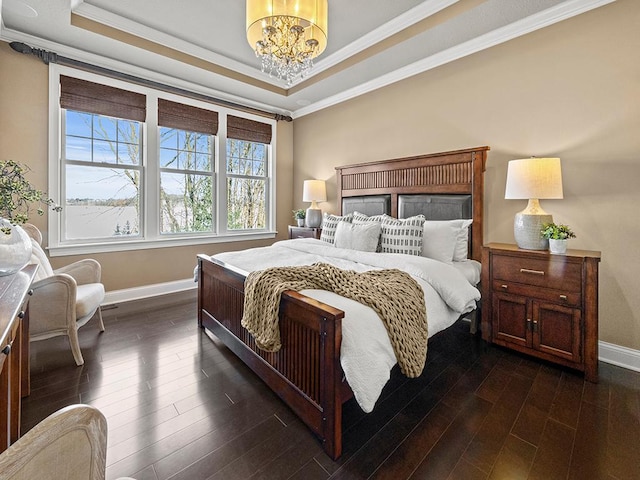 bedroom featuring a chandelier, crown molding, dark hardwood / wood-style flooring, and a tray ceiling