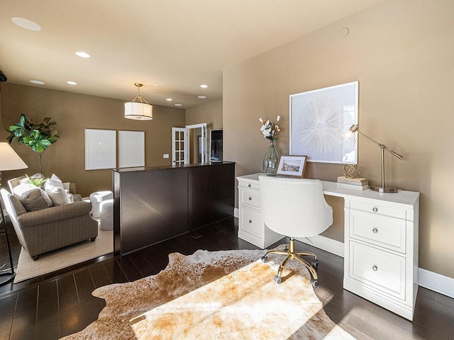 home office featuring built in desk and dark hardwood / wood-style flooring