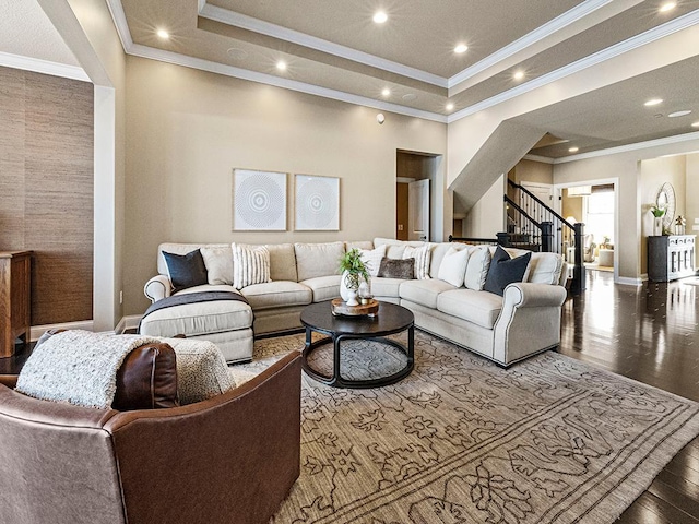 living room featuring hardwood / wood-style flooring, crown molding, and a raised ceiling