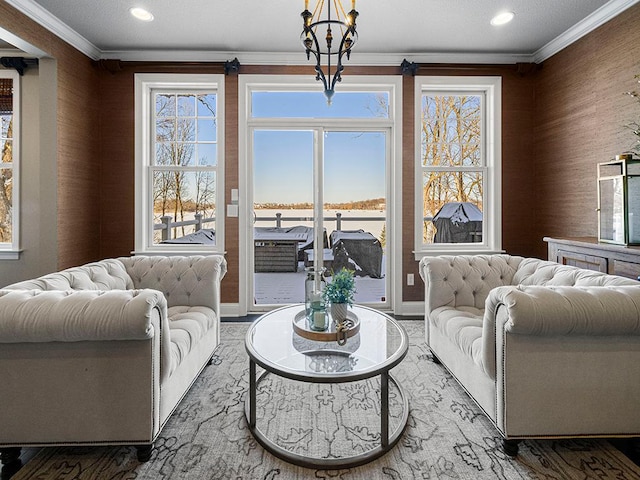 living room featuring ornamental molding and a chandelier