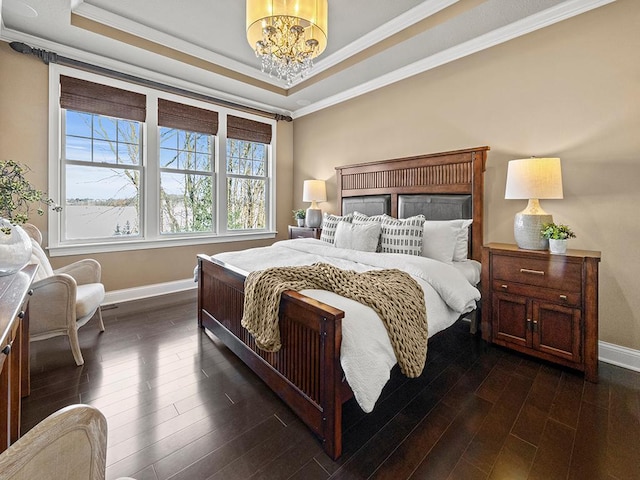 bedroom with a tray ceiling, crown molding, and dark hardwood / wood-style floors