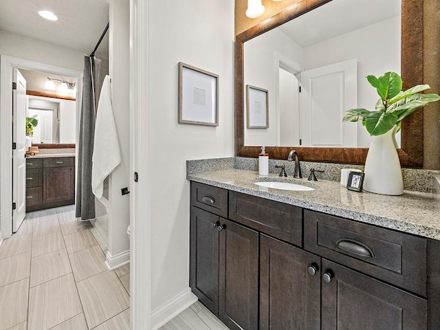 bathroom featuring shower / bath combo with shower curtain and vanity