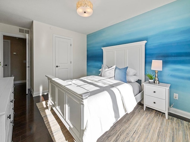 bedroom with dark wood-type flooring