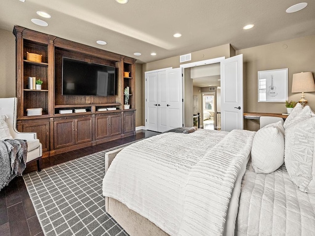 bedroom with dark wood-type flooring