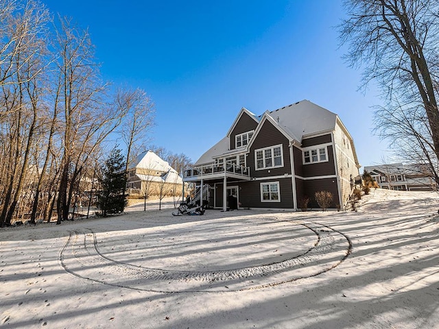 rear view of house featuring a wooden deck