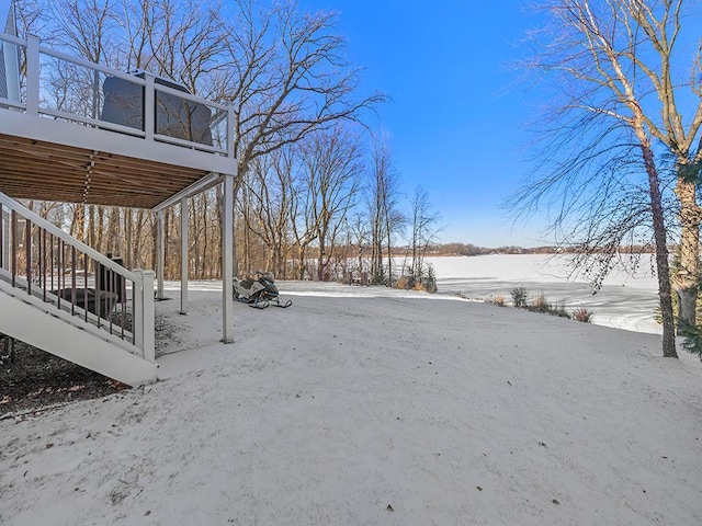 yard layered in snow with a sunroom