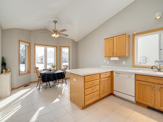 kitchen featuring dishwasher, sink, a wealth of natural light, and kitchen peninsula