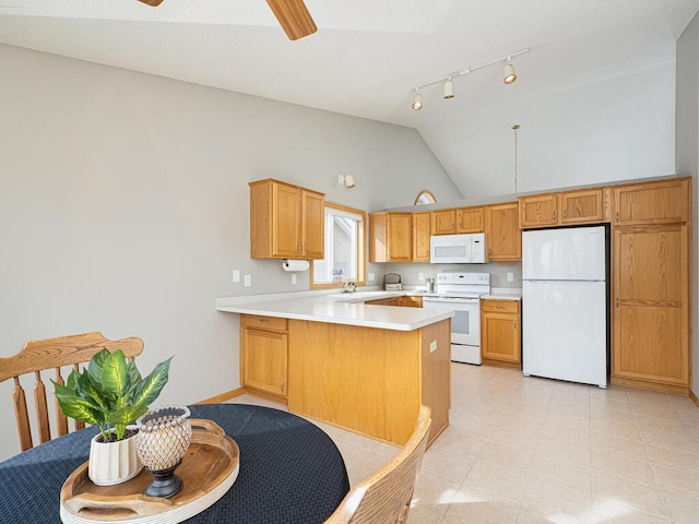 kitchen with sink, white appliances, ceiling fan, vaulted ceiling, and kitchen peninsula