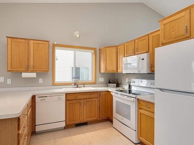 kitchen with sink, white appliances, vaulted ceiling, and light tile patterned floors