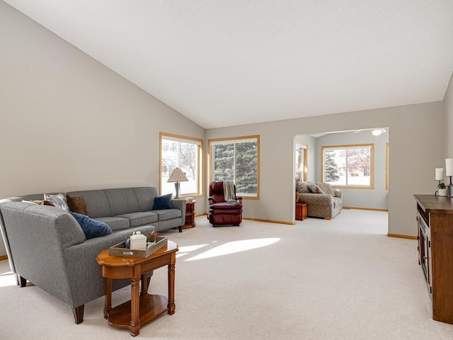 living room featuring lofted ceiling and light carpet