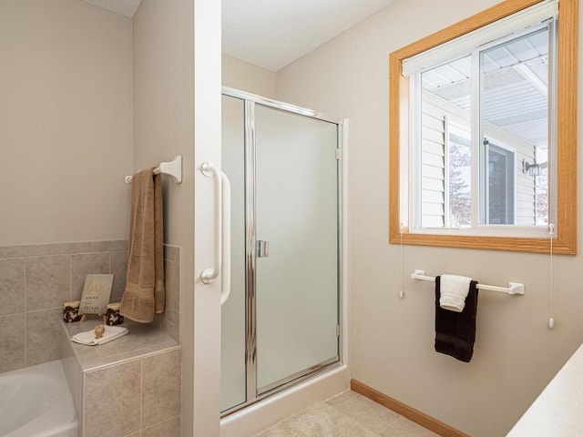 bathroom with tile patterned floors and separate shower and tub