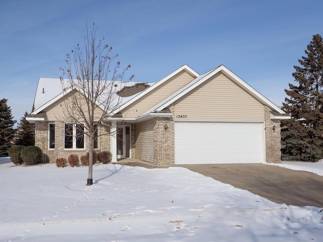 ranch-style house featuring a garage and brick siding