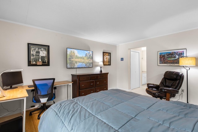 bedroom featuring light wood-type flooring and ornamental molding