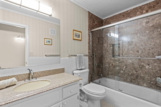 full bathroom featuring vanity, toilet, enclosed tub / shower combo, a textured ceiling, and tile walls