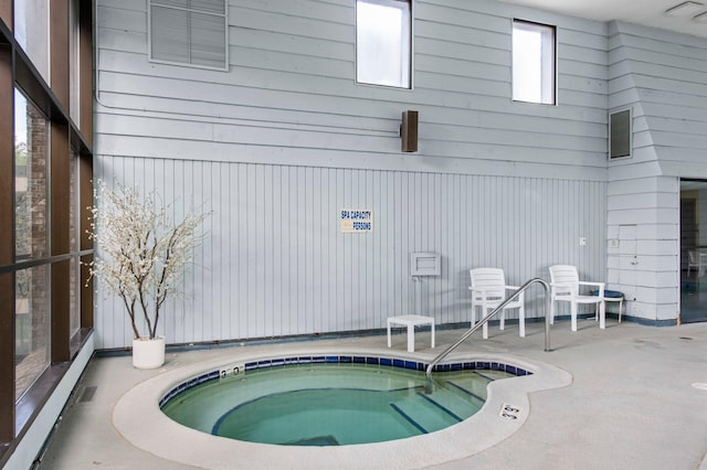 view of swimming pool featuring an indoor hot tub and a patio