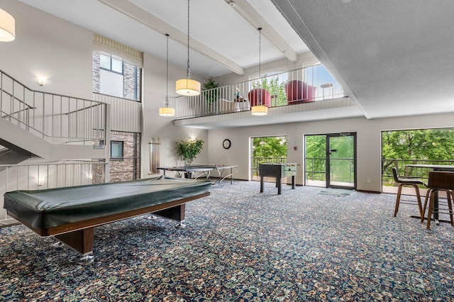 game room featuring beam ceiling, plenty of natural light, a high ceiling, and billiards