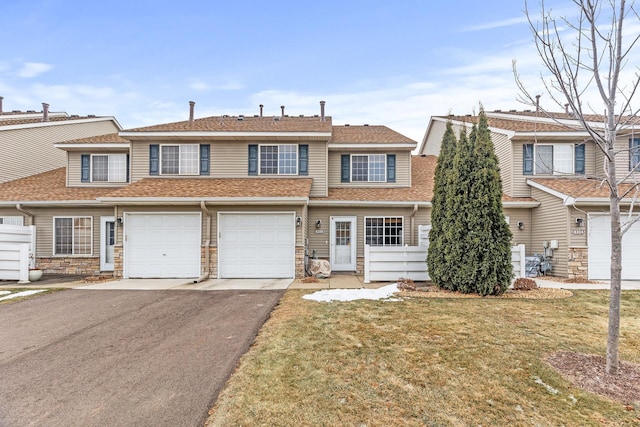 view of property featuring a front yard and a garage