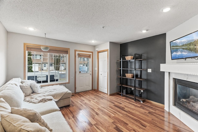 living room with hardwood / wood-style floors and a textured ceiling