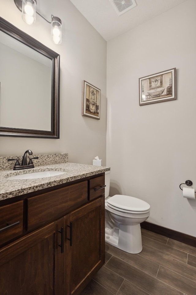 bathroom with vanity and toilet