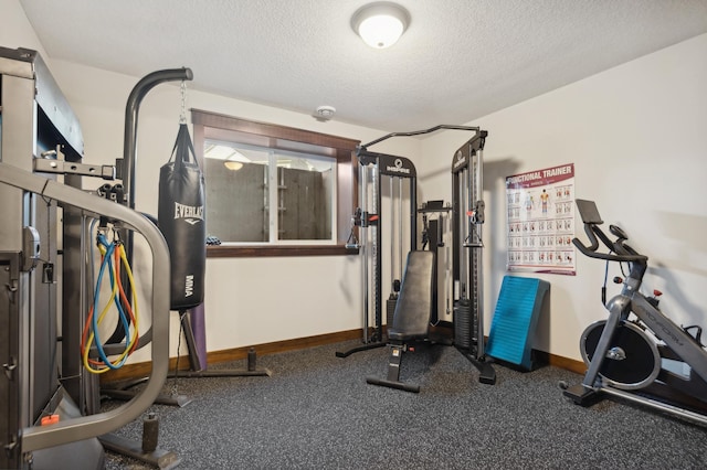 workout room featuring a textured ceiling