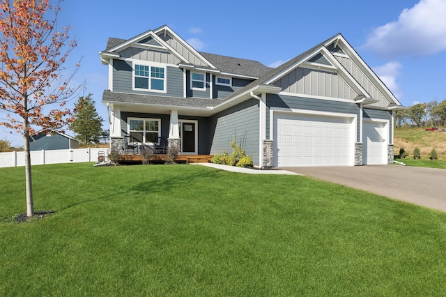 craftsman house with a front yard, a garage, and a porch