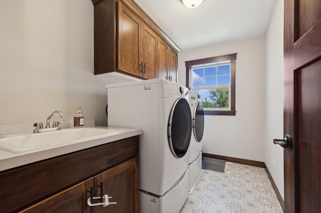 washroom featuring sink, independent washer and dryer, cabinets, and light tile patterned floors