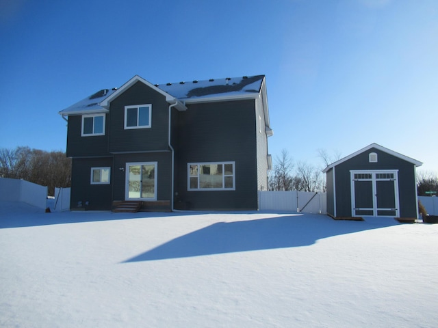 snow covered property with an outdoor structure