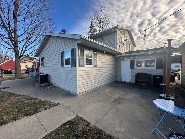 back of house with central AC and a patio