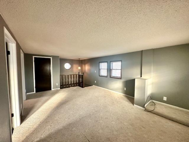 interior space featuring a textured ceiling and carpet floors