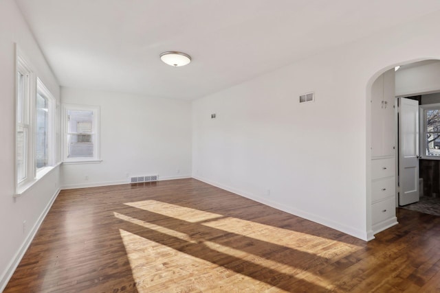 spare room featuring dark hardwood / wood-style flooring