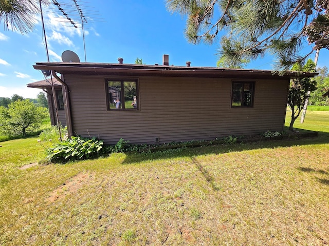 view of side of property with a lawn