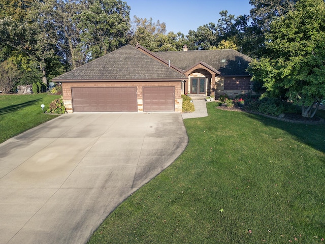 view of front of home featuring a garage and a front yard