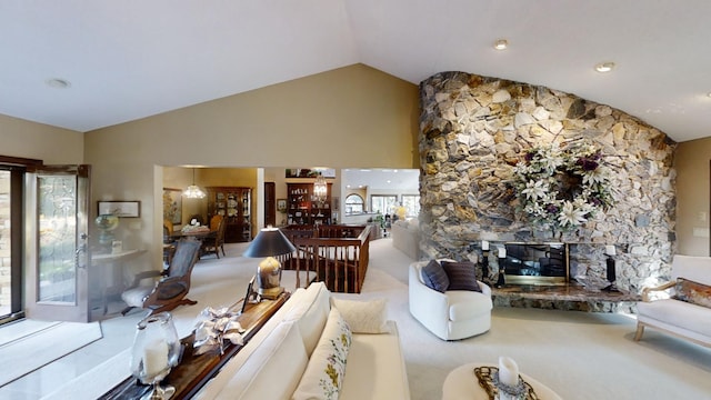 carpeted living room featuring a fireplace and lofted ceiling