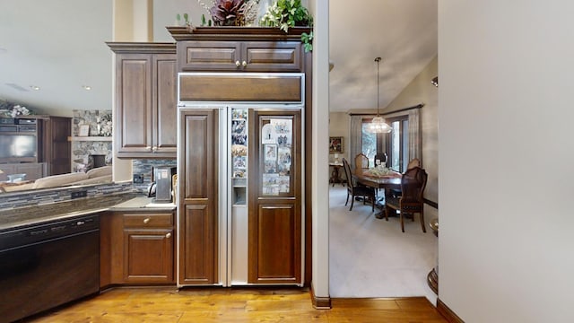 kitchen with dishwasher, paneled built in refrigerator, vaulted ceiling, and light hardwood / wood-style flooring