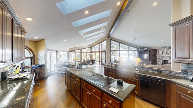 1516 Bay Oaks Dr, Albert Lea, MN 56007 - kitchen with open floor plan, black appliances, light wood-style flooring, a center island, and recessed lighting