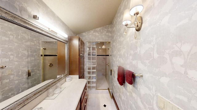 bathroom featuring tile patterned floors, vanity, a textured ceiling, a shower with door, and lofted ceiling