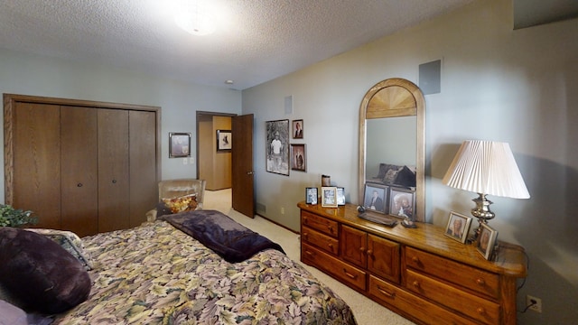 carpeted bedroom with a closet and a textured ceiling