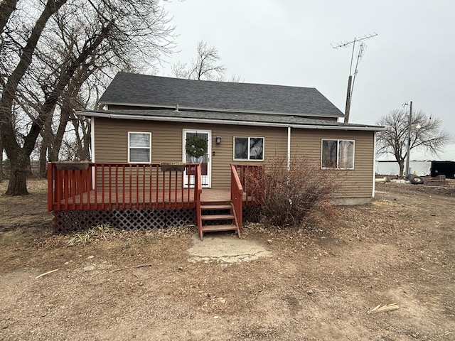 back of house featuring a wooden deck