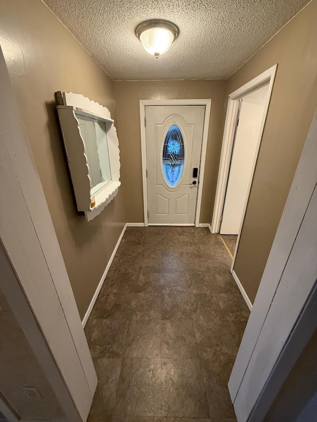 entryway with a textured ceiling