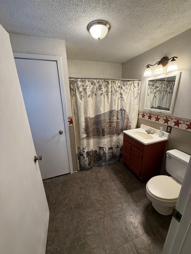 bathroom featuring vanity, toilet, a textured ceiling, and walk in shower