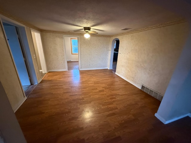 unfurnished room with hardwood / wood-style floors, ceiling fan, and crown molding