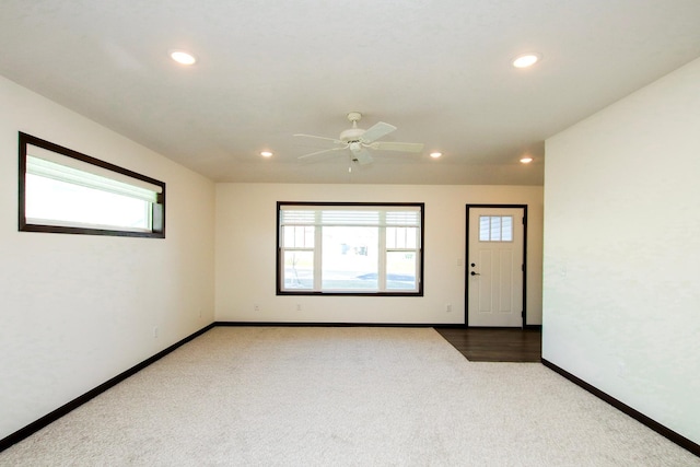 carpeted spare room featuring ceiling fan